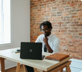 African American male on a computer sitting at a desk